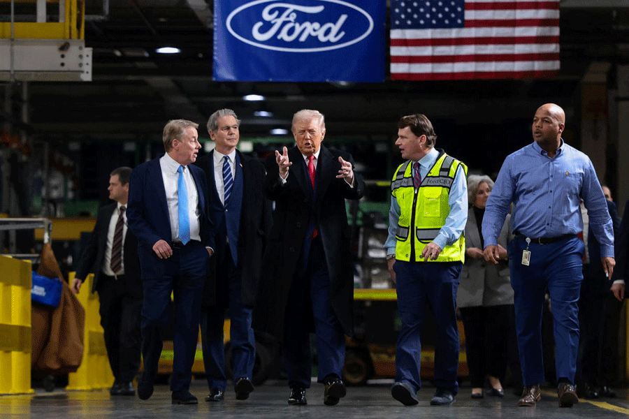 U.S. President Donald Trump walks with Treasury Secretary Scott Bessent, Bill Ford, Executive Chairman of Ford, Jim Farley, CEO of Ford and Corey Williams, Ford River Rouge Plant Manager, during President Trump's visit to a Ford production center in Dearborn, Michigan, U.S., January 13, 2026.