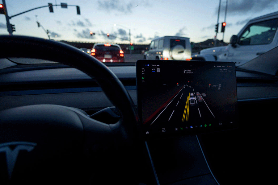 FILE PHOTO: Tesla Model 3 uses autopilot FSD beta to navigate city streets in California