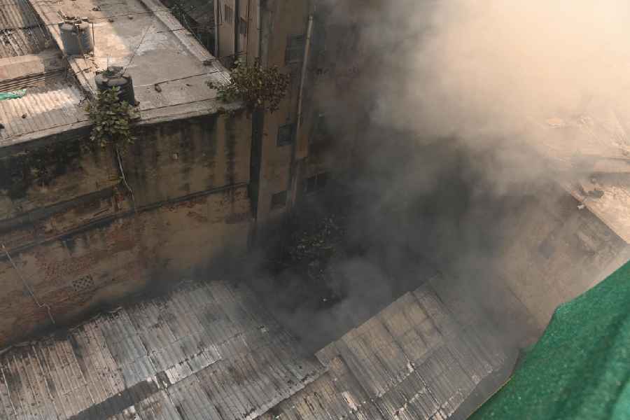 Smoke rises from a cluster of shops on BB Ganguly Street, where the fire broke out on Wednesday morning.