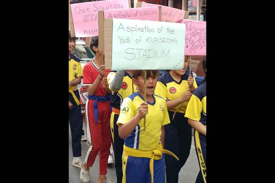 Sports lovers, including children, take part in a rally for a stadium in Kurseong