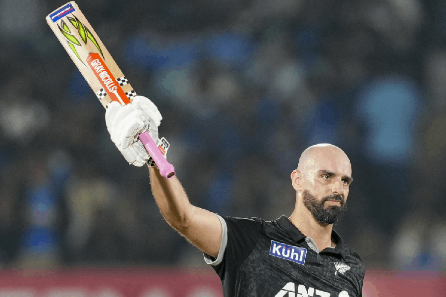 New Zealand's Daryl Mitchell celebrates his century during the second ODI cricket match between India and New Zealand, at Niranjan Shah Stadium, in Rajkot, Gujarat, Wednesday, Jan. 14, 2026.