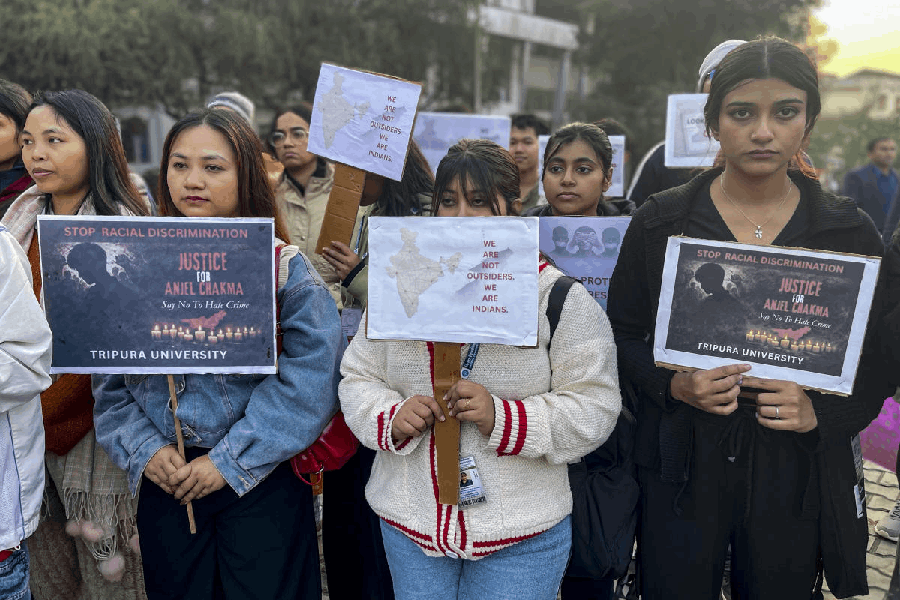 Tripura University students hold placards during a protest inside the campus demanding justice for Anjel Chakma, in Agartala.