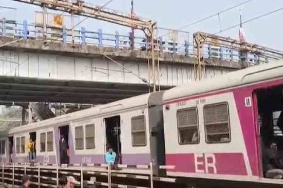 A train passes under the Belgharia railway bridge