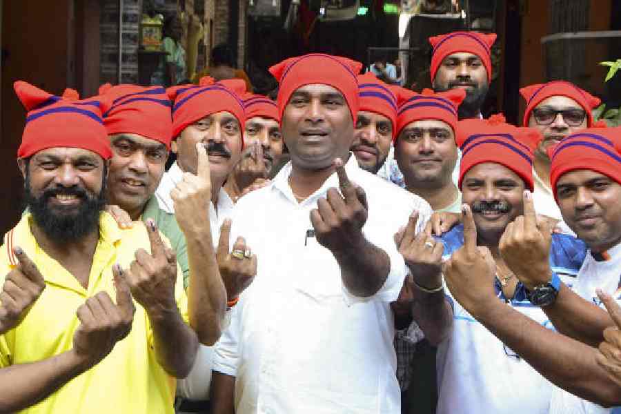 Voters show their ink-marked fingers after casting their votes at a polling station during the Brihanmumbai Municipal Corporation elections in Mumbai on Thursday.