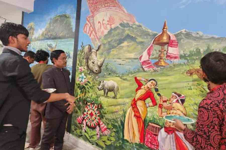 Young artists show EZCC director Ashis Giri their work on the Assam mural on the ground floor