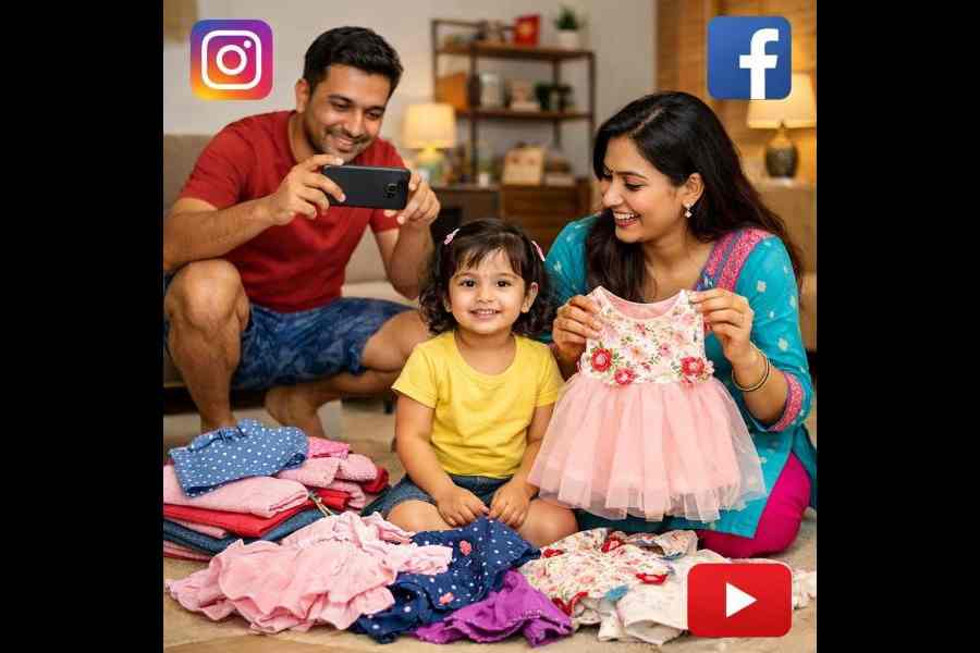 A father does a photo shoot of a child being dressed in new clothes by the mother to post on social media.