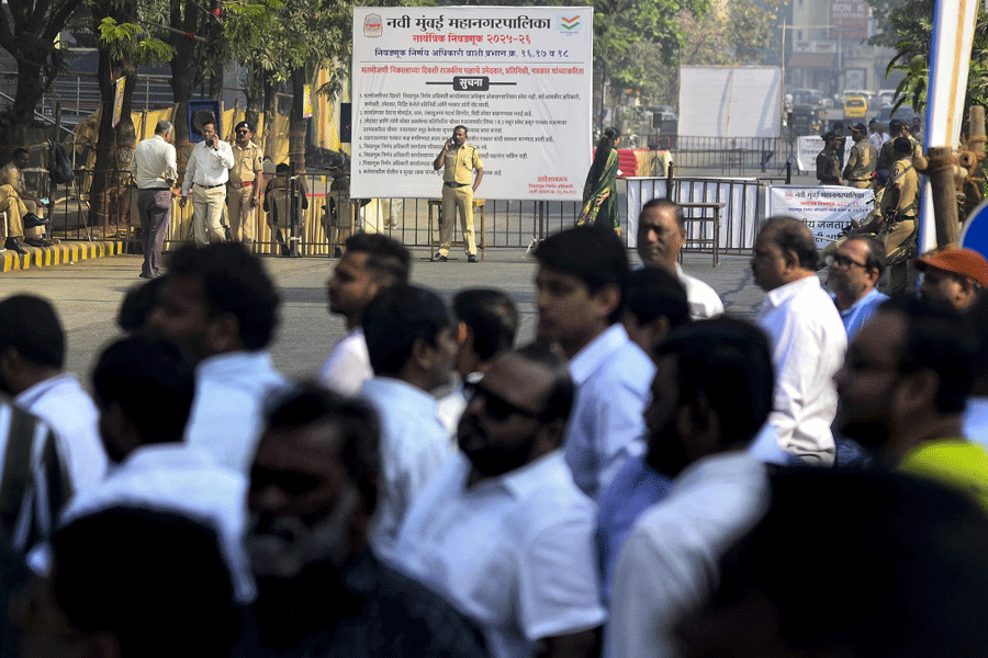 Security personnel keep vigil outside a centre during counting of votes for the Navi Mumbai Municipal Corporation election, at Vashi, in Navi Mumbai, Friday, Jan. 16, 2026.