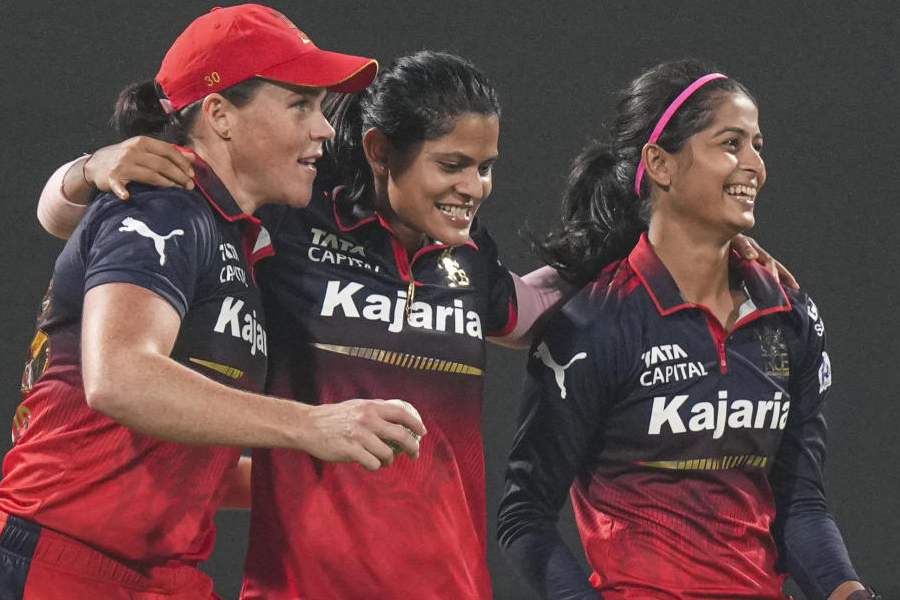 Royal Challengers Bengaluru's Shreyanka Patil, right, Radha Yadav, 2nd right, and Grace Harris during the Women's Premier League (WPL) T20 cricket match between Royal Challengers Bengaluru and Gujarat Giants, at the DY Patil Stadium, in Navi Mumbai, Friday, Jan. 16, 2026.