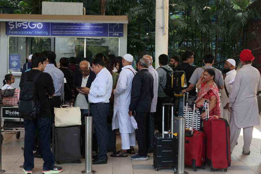 Passengers wait outside the IndiGo ticket counter at Mumbai airport’s Terminal-1 on December 5 after several flights were cancelled.