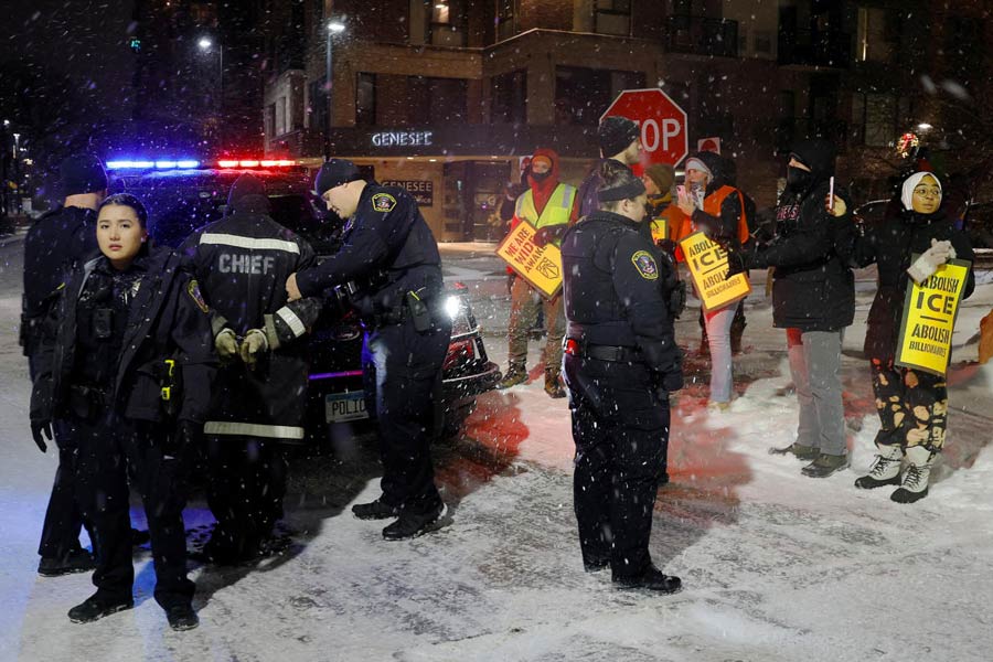 A protestor is detained by police for violating local noise ordinances at a demonstration against increased immigration enforcement outside a hotel that demonstrators believe is being used by federal agents, after the fatal shooting of Renee Nicole Good by a U.S. Immigration and Customs Enforcement (ICE) agent, in Bloomington, Minnesota, U.S., January 16, 2026.