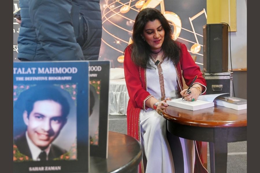 Zaman signs her book