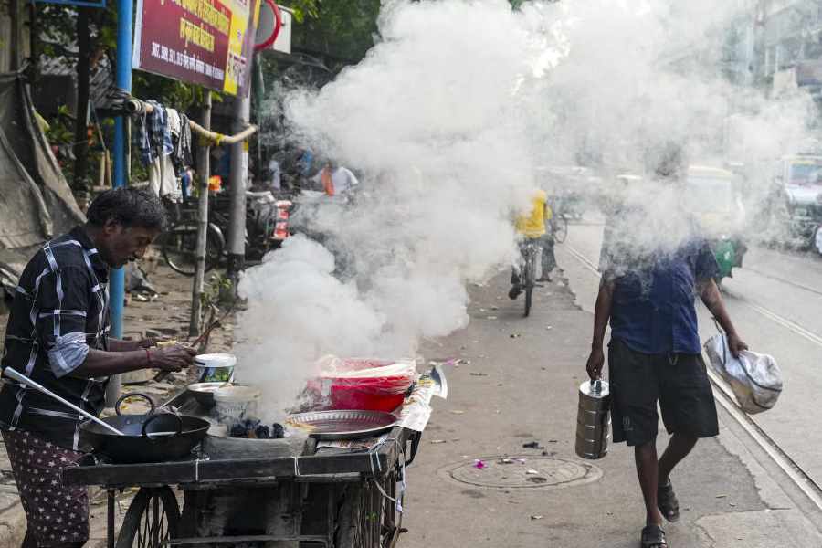 Smoke billows from coal being burnt in a traditional stove at a roadside cart, in Kolkata, West Bengal, Thursday, Oct. 23, 2025. Hospitals across Kolkata have reported a significant rise in respiratory illnesses among people and complications among pregnant women and IVF patients after Diwali and Kali Puja celebrations, with doctors attributing the surge to heightened air and noise pollution caused by bursting of firecrackers
