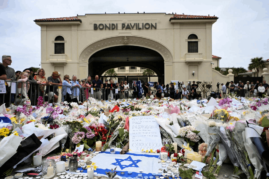 File photo: People stand near flowers laid as a tribute at Bondi Beach to honour the victims of a mass shooting that targeted a Hanukkah celebration at Bondi Beach on Sunday, in Sydney, Australia, December 16, 2025.