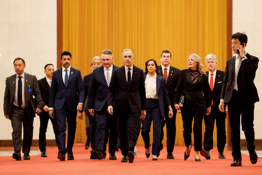 Canada's Prime Minister Mark Carney walks with Canada's Foreign Minister Anita Anand, Minister of International Trade Maninder Sidhu, Steven MacKinnon, Minister of Transport Minister of Industry Melanie Joly, Minister of Energy and Natural Resources Tim Hodgson and members of Canadian delegation ahead of his meeting with Chinese President Xi Jinping, during the first visit by a Canadian prime minister to China since 2017, at the Great Hall of the People, in Beijing, China, January 16, 2026.