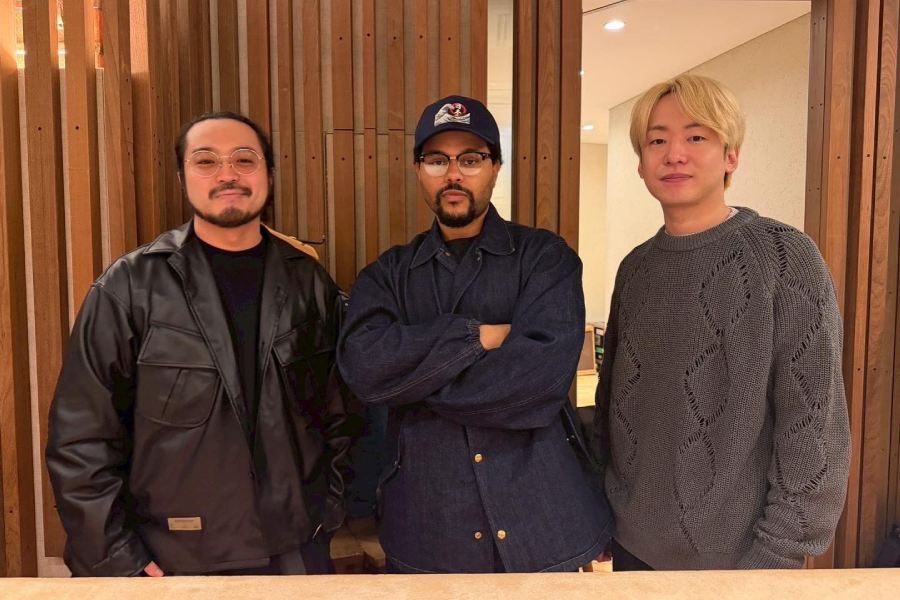 Creepy Nuts, consisting of DJ Matsunaga and R-Shitei, pose with The Weeknd