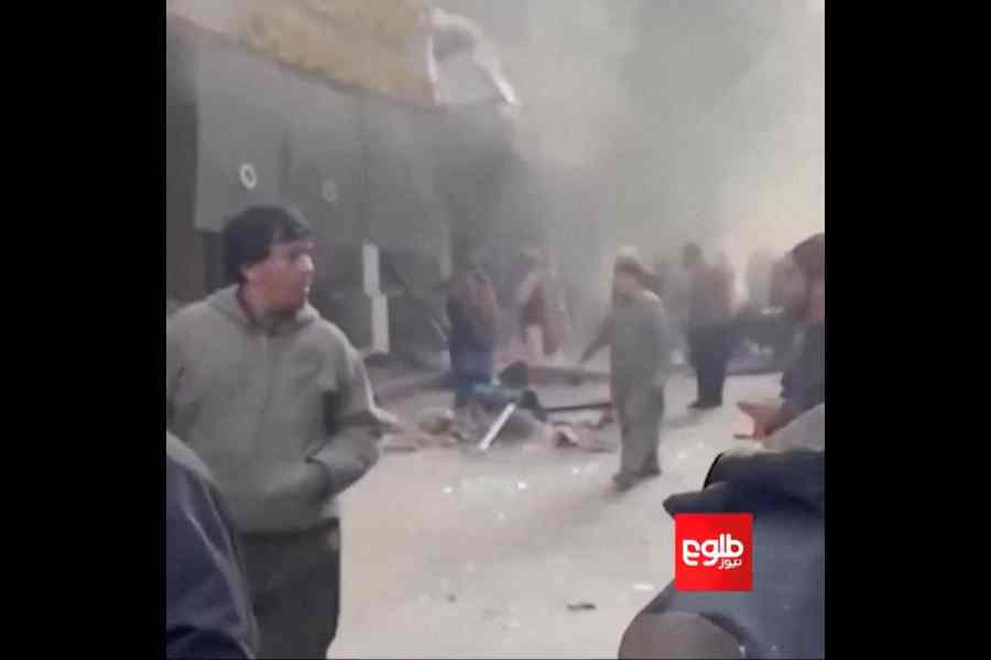 People gather near the site of the blast in Kabul on Monday.