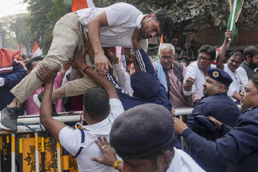 Congress workers jump over police barricades during a protest march against the SIR outside the chief electoral officer’s office in Calcutta, on Tuesday.