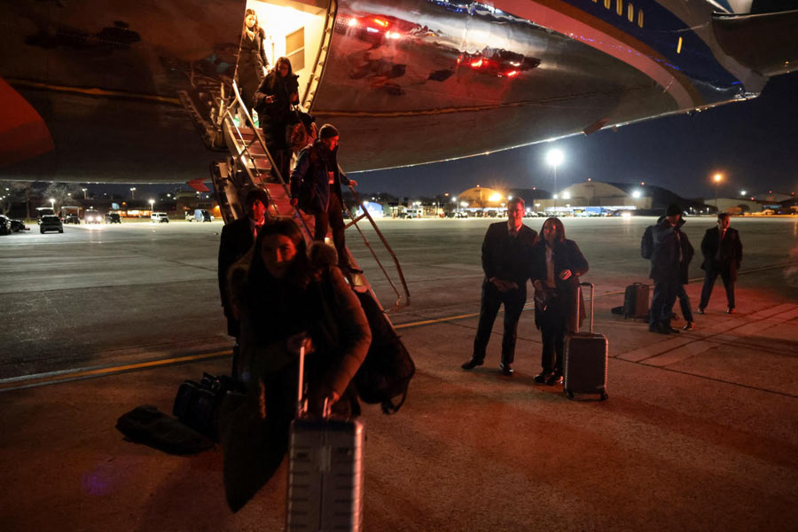 Members of the media deboard Air Force One after returning to Joint Base Andrews following an electrical problem identified mid-flight en route to Davos, Switzerland, at Joint Base Andrews, Maryland, U.S., January 20, 2026.