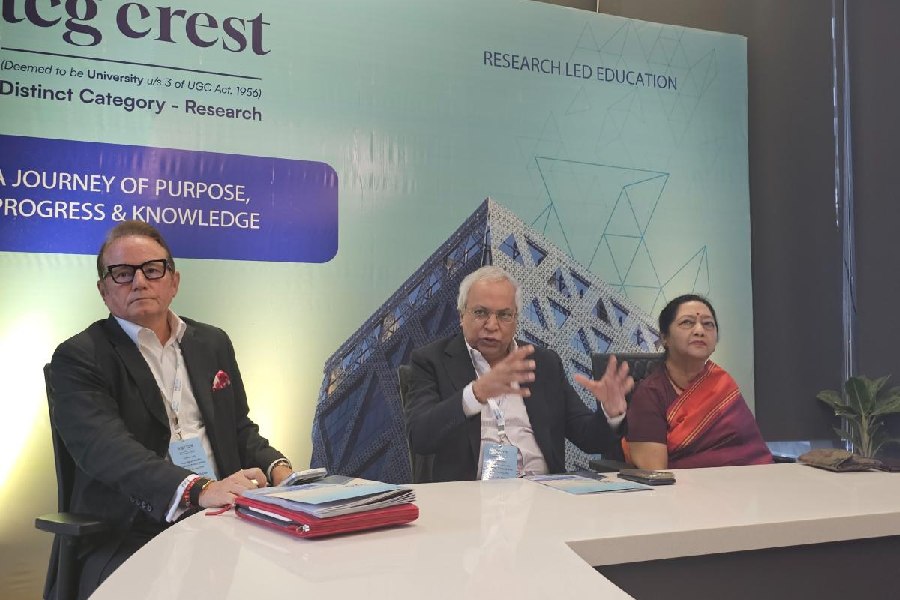 Purnendu Chatterjee, chairman and chancellor of TCG Crest, speaks at a conference. He is flanked by Jeremy Ghose, president, TCG, and Malabika Sarkar, mentor and officiating VC, TCG Crest.