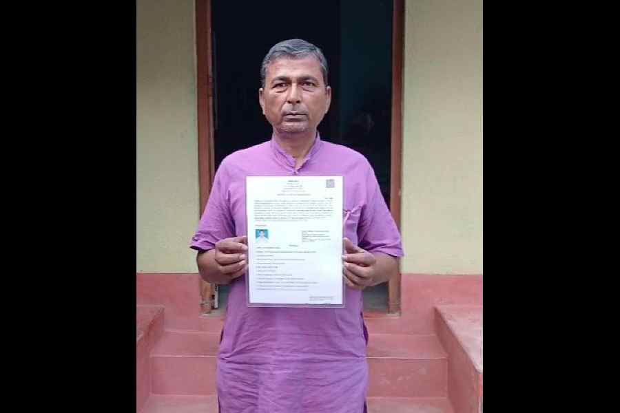 Satya Ranjan Barui, in Malda on Wednesday, shows his Indian citizenship certificate issued under the CAA.