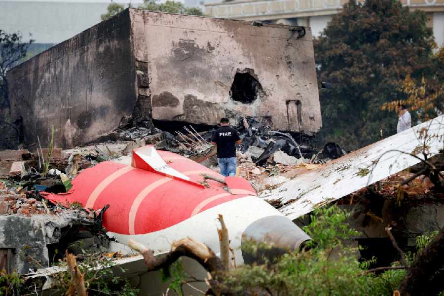 A firefighter stands next to the crashed Air India Boeing 787-8 Dreamliner aircraft, in Ahmedabad