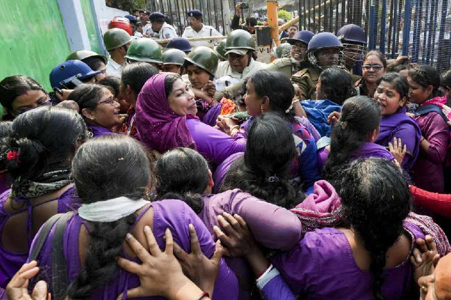 Police personnel detain ASHA workers during a sit-in protest at Health Bhavan amidst an ongoing work stoppage called by the West Bengal ASHA Workers’ Union, in Kolkata