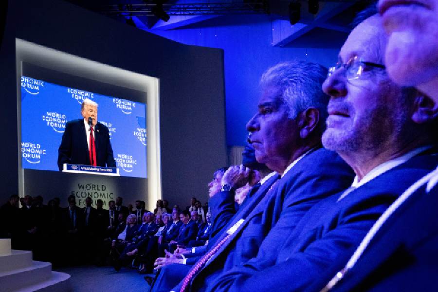 President Donald Trump is visible on a video monitor as he addresses the World Economic Forum in Davos, Switzerland, on Wednesday, Jan. 21, 2026.