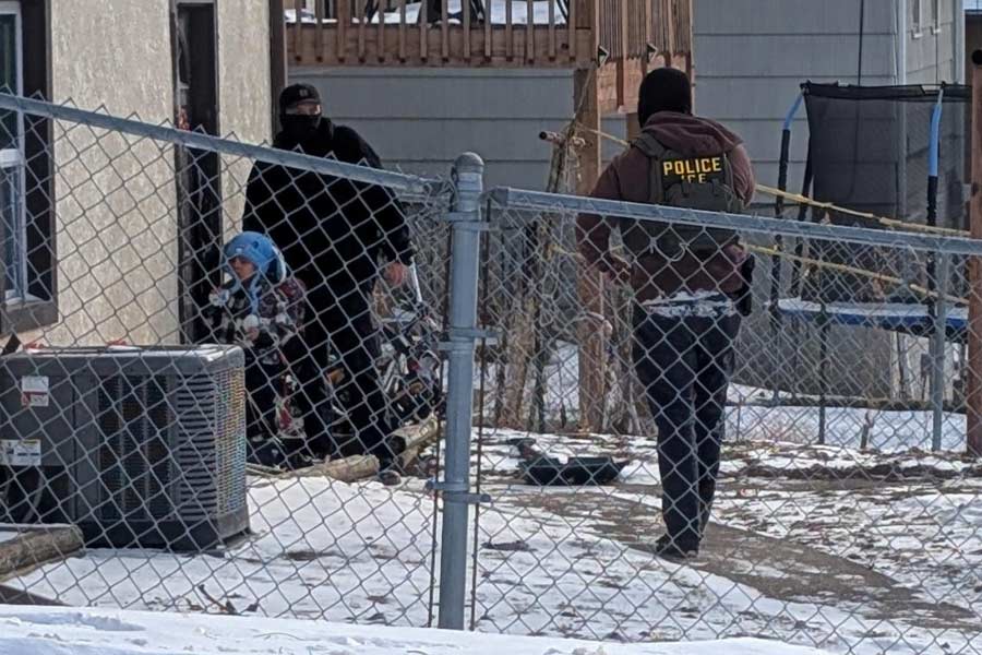 ICE agents stand next to a boy, who a witness identified as Liam Conejo Ramos, a five-year-old that school officials said was detained in Minneapolis, Minnesota, U.S., January 20, 2026.