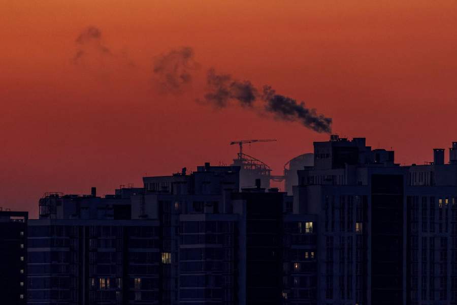 Water vapour rises from residential buildings' autonomous heating systems during a power blackout and freezing temperatures, after critical civil infrastructure was hit by recent Russian missile and drone attacks