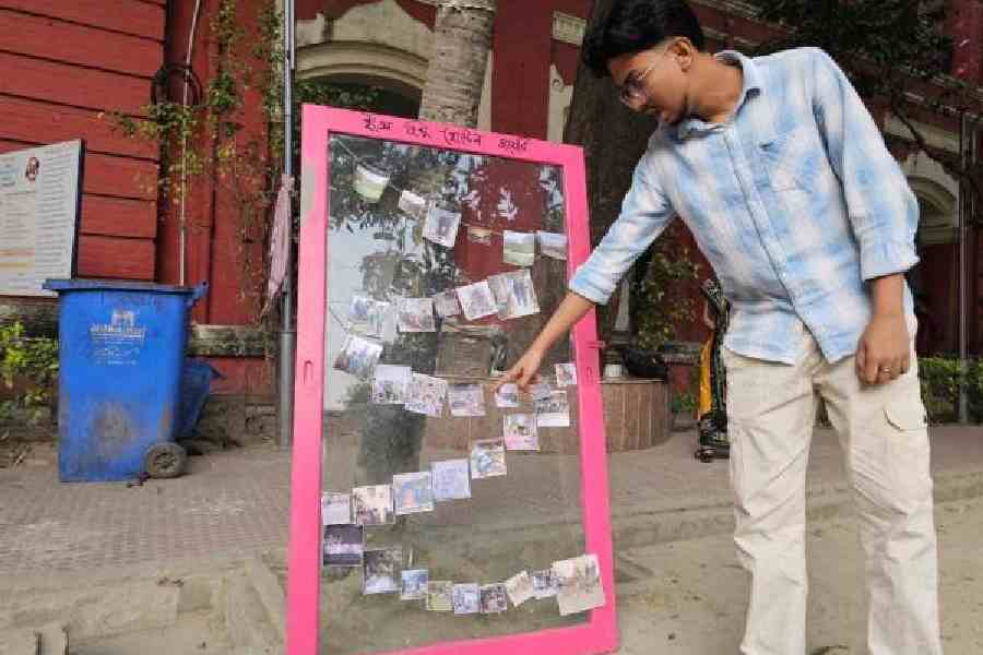 Rajibul Rahaman points to pictures of the student agitation to reopen the hostel. (Sudeshna Banerjee)