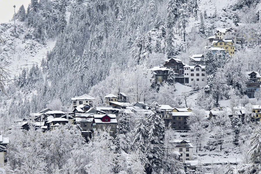 Houses and mountains covered with snow after fresh snowfall, in Doda district of Jammu and Kashmir