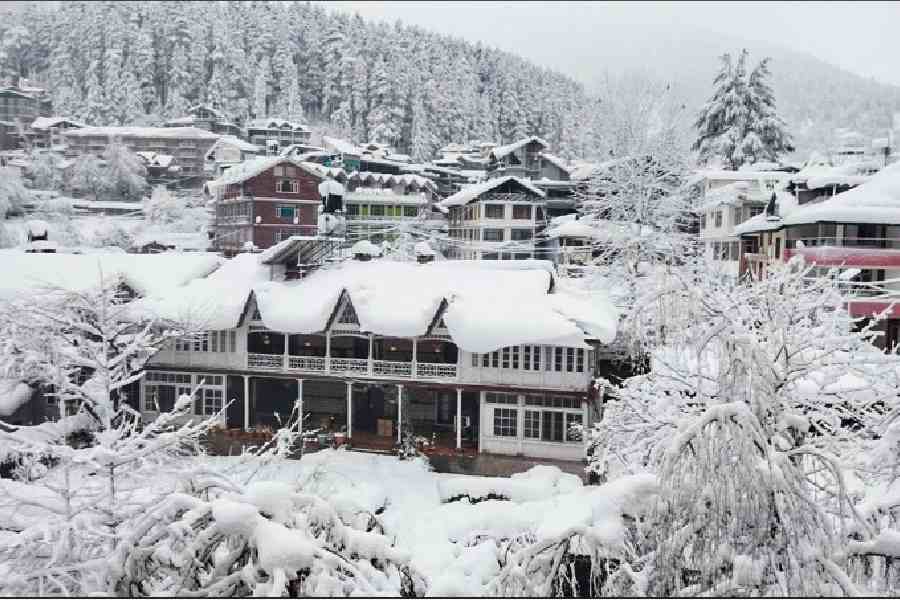 Snow-covered homes in Manali on Friday morning