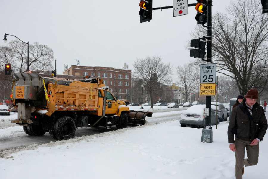 A snowplow truck works on the road as a major winter storm spreads across a large swath of the United States, in Washington