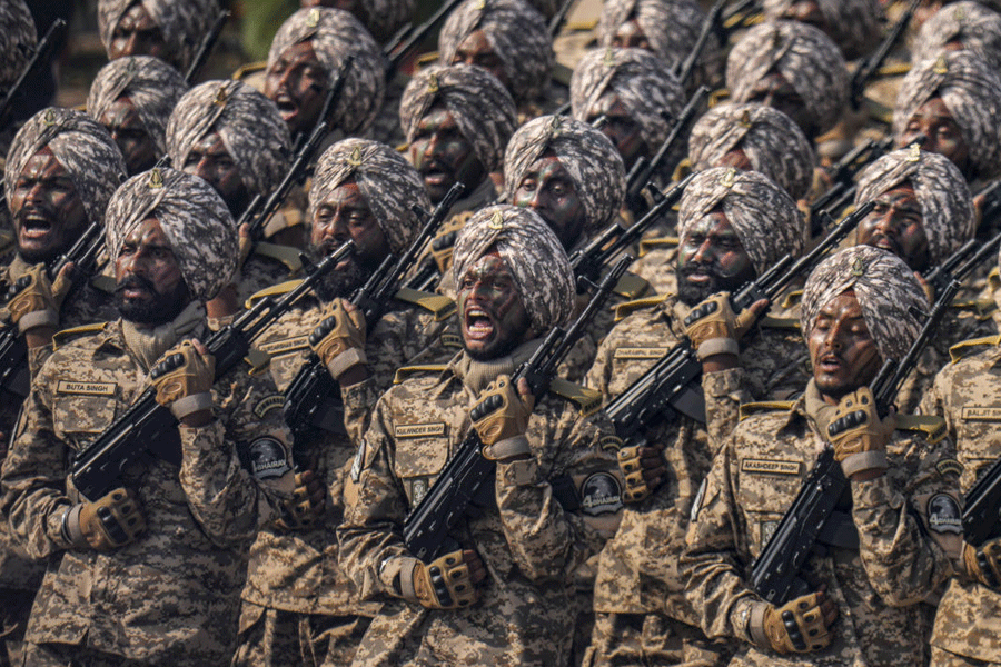 The 4 BHAIRAV Battalion contingent of the Sikh Light Infantry Regiment marches during the 77th Republic Day Parade at Kartavya Path