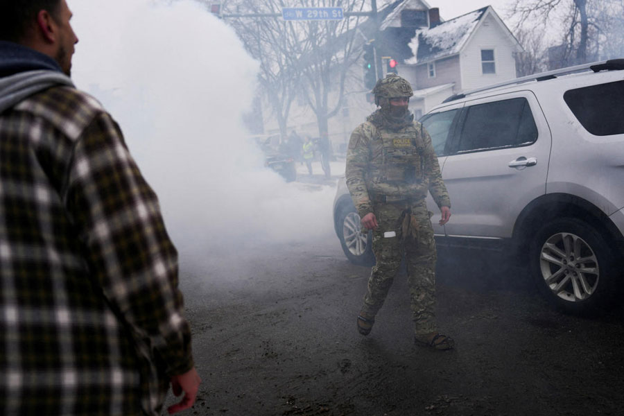 FILE PHOTO: A federal agent walks surrounded by tear gas used to deter protesters, as immigration enforcement continues after a U.S. Immigration and Customs Enforcement (ICE) agent fatally shot Renee Nicole Good on January 7 during an immigration raid, in Minneapolis, Minnesota, U.S., January 21, 2026.