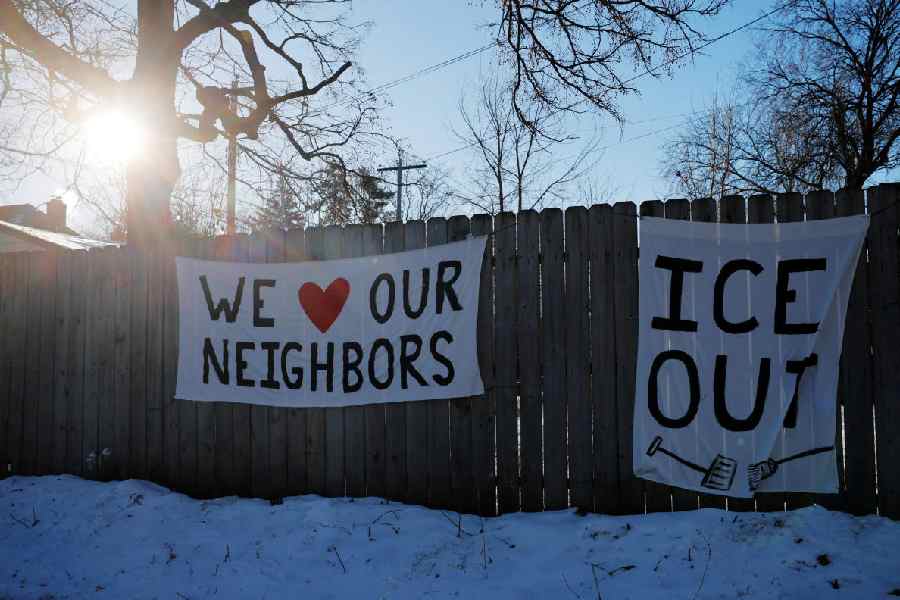 Signs opposing federal immigration enforcement actions hang in a neighborhood, after the fatal shootings of Renee Nicole Good and Alex Pretti by federal immigration agents, in Minneapolis