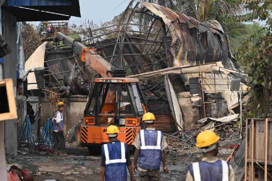A payloader clears debris at the fire-ravaged site in Anandapur on Thursday.            Picture by Sanat Kr Sinha