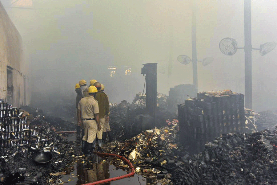 Fire brigade personnel douse a fire at a warehouse, in Kolkata, Monday, Jan. 26, 2026.