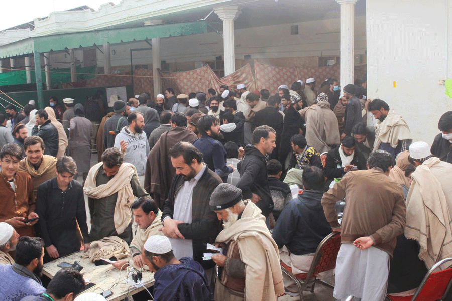 Residents from Tirah valley, who fled a remote mountainous region bordering Afghanistan, gather to get themself registered, in Bara