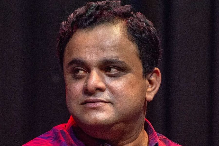 People gather near the charred remains of a fire at a warehouse, in Kolkata, Monday, Jan. 26, 2026.