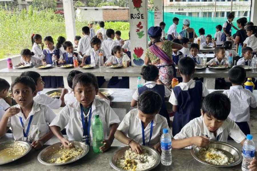Students at a Jalpaiguri school have a midday meal