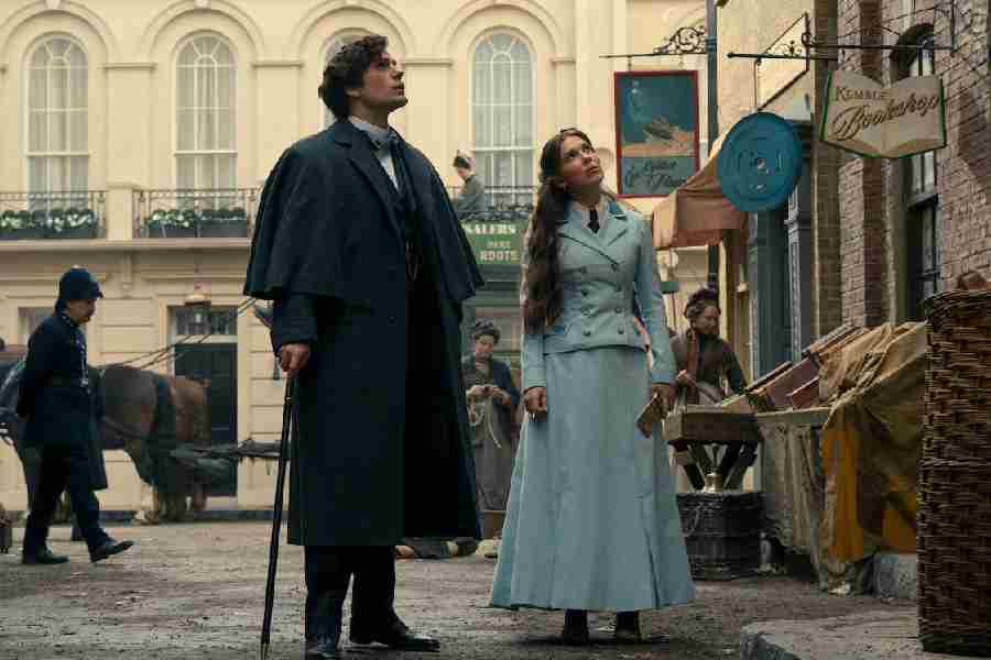 Henry Cavill (left) plays the legendary detective Sherlock Holmes, Enola’s elder brother, in the film
