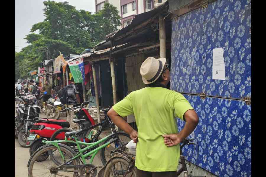 A customer reads the eviction notice on Monday morning, served by NKDA on the market on June 25 
