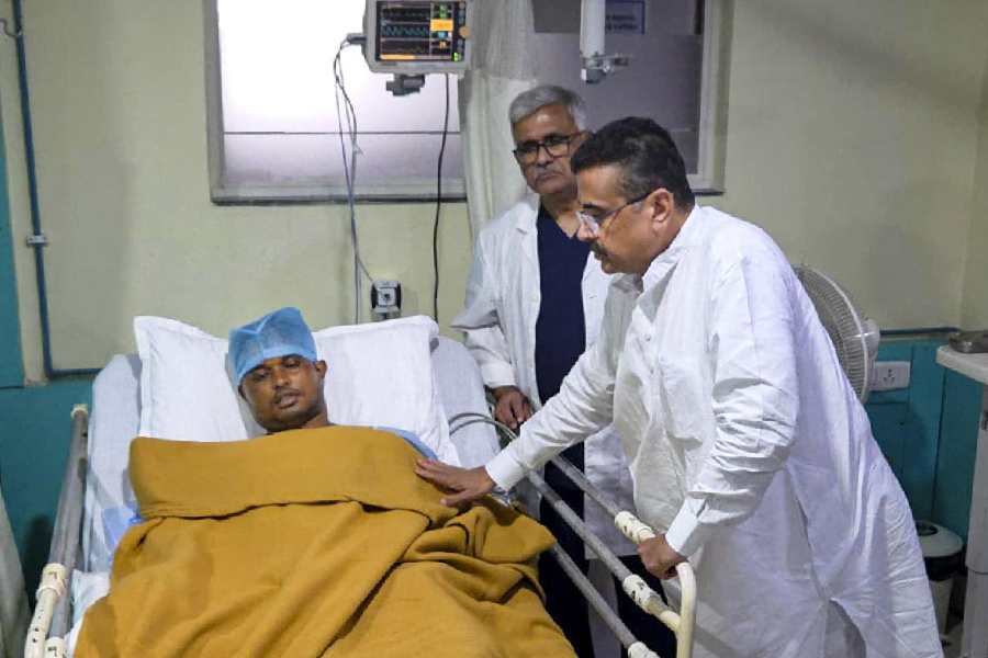 In this image received on July 7, 2026, West Bengal Chief Minister Suvendu Adhikari interacts with a police personnel, who got injured in a mob lynching incident on Sunday, when the mortal remains of an 11-year-old girl were found in Baruipur, followed by an alleged gangrape and murder case, in Kolkata.