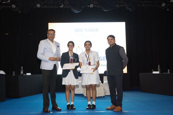 Azad Ali (extreme left) and Rajeev Kumar Singh (extreme right) felicitate Trisha Kaur Ahluwalia and Tiana Purohit from La Martiniere for Girls at the Shiv Nadar Think Challenge 2026 at Tollygunge Club