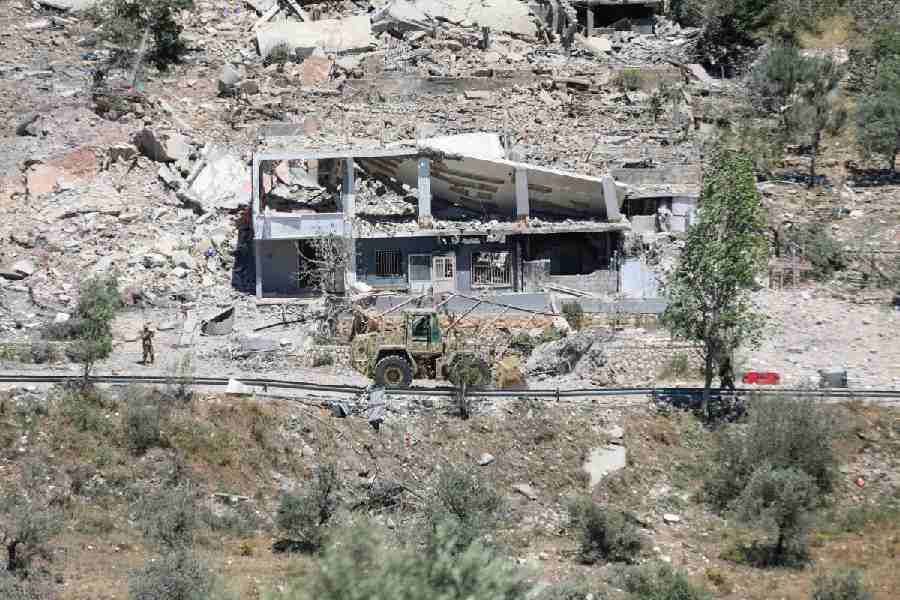 Machinery operates, as the Lebanese army opens a road, past buildings destroyed during the Israeli military campaign, in Dibbin, southern Lebanon June 4, 2026.