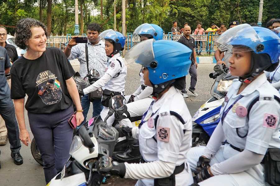US Consul General Kathy Giles-Diaz greets Kolkata Police women riders before the rally
