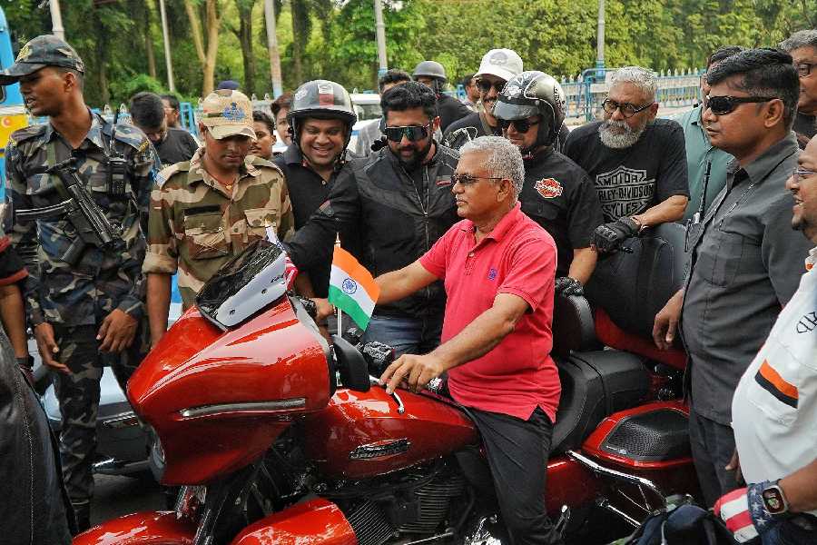 State minister Dilip Ghosh checks out a Harley-Davidson before the rally