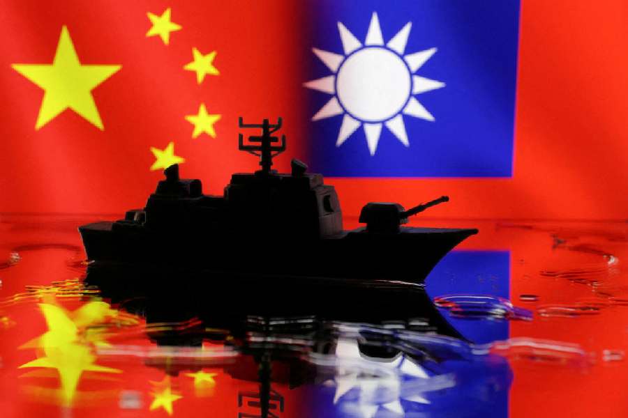 A Navy miniature is seen in front of displayed Chinese and Taiwanese flags in this illustration taken, April 11, 2023.