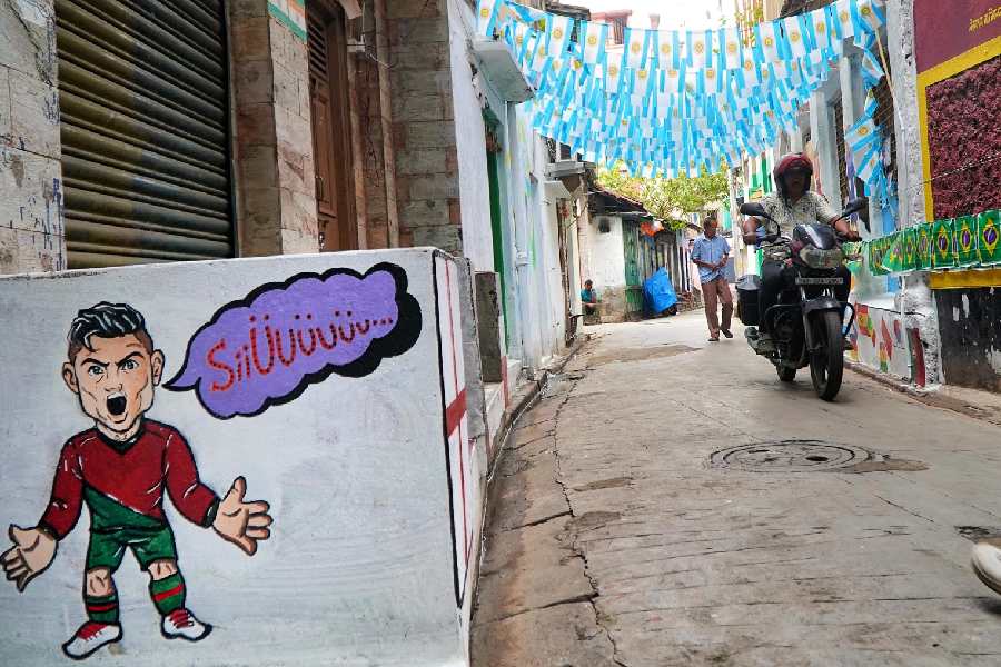 A lane in north Kolkata with various football references, ready for World Cup 2026